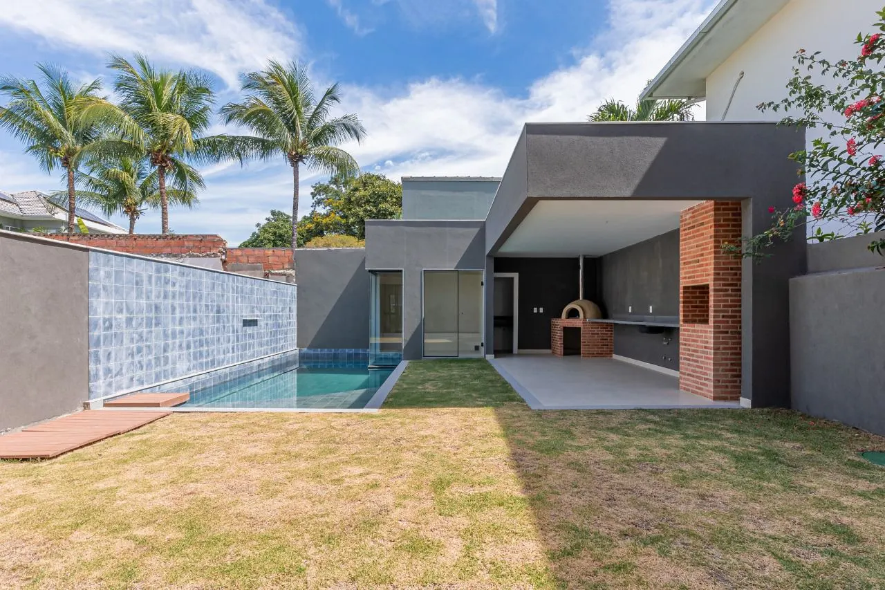 Quintal com gramado, piscina com borda em pastilha, área gourmet com forno de pizza e churrasqueira